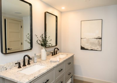 bathroom vanity with two sinks and black rectangular mirrors