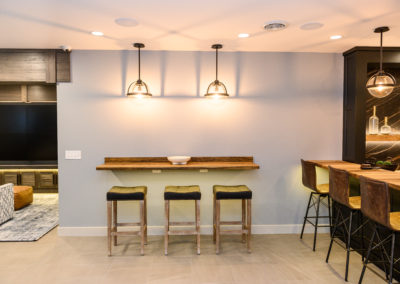three barstools on a wall counter seating area