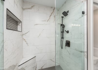 white and grey shower with dark fixtures