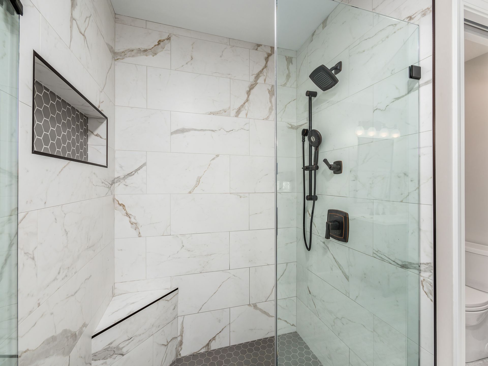 white and grey shower with dark fixtures