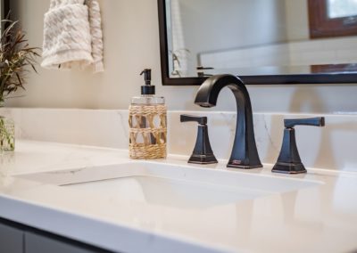 dark faucet on a white countertop
