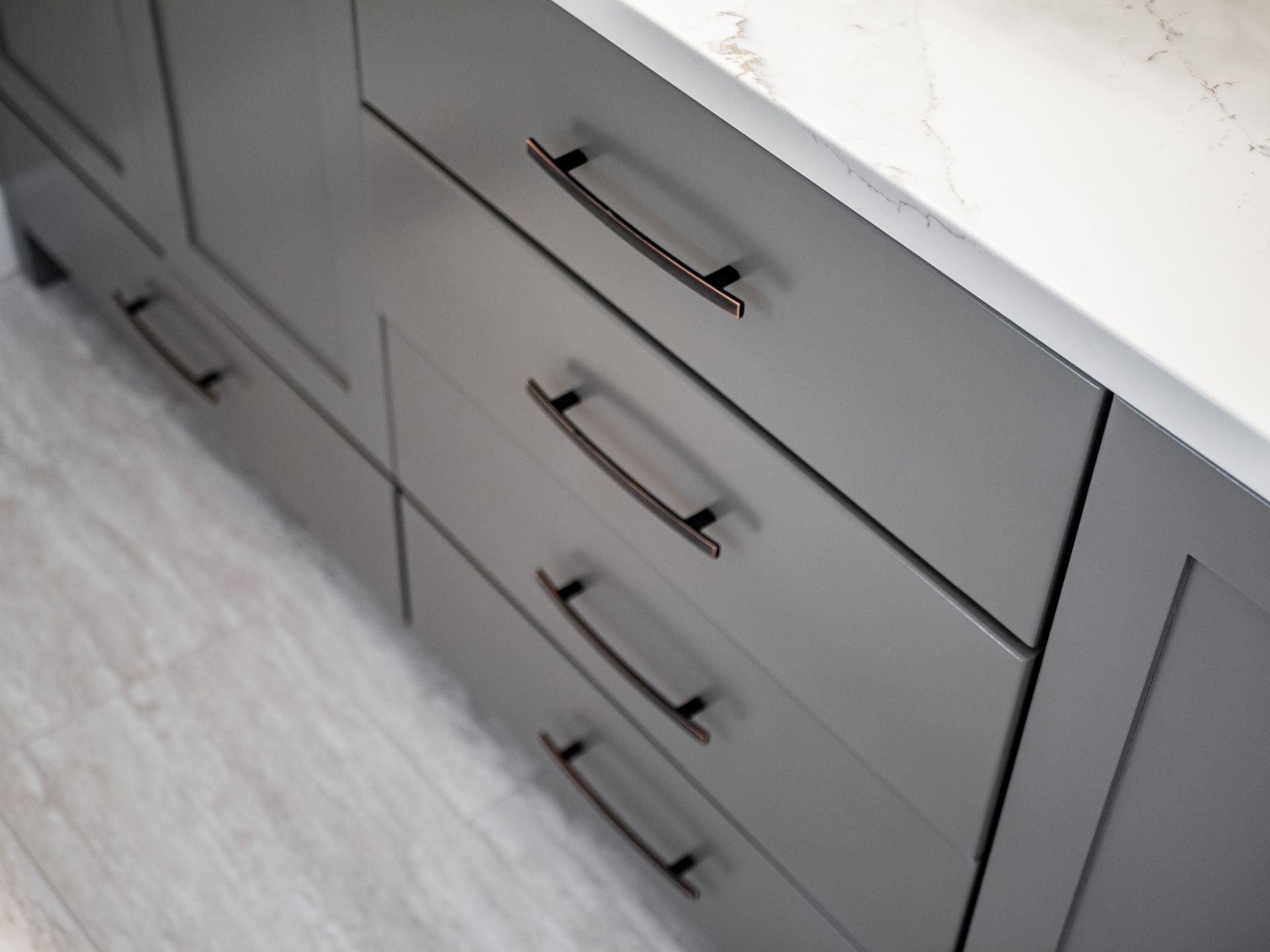 grey vanity, white countertop, dark handles