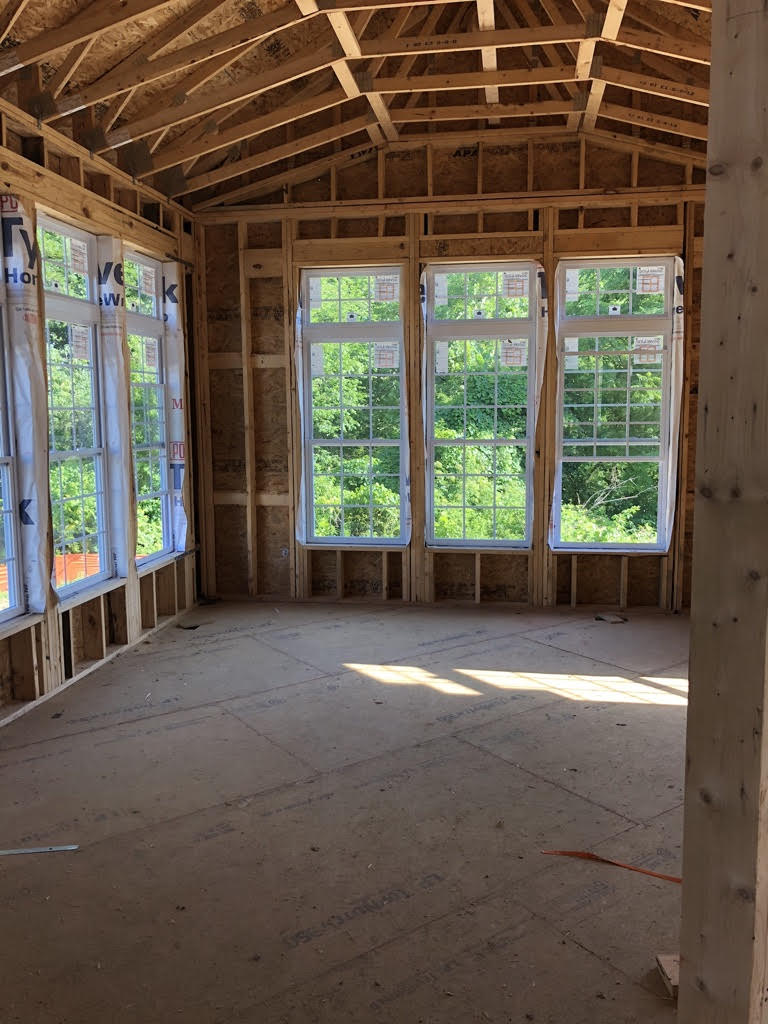 new construction of a home showing the living room framing with windows