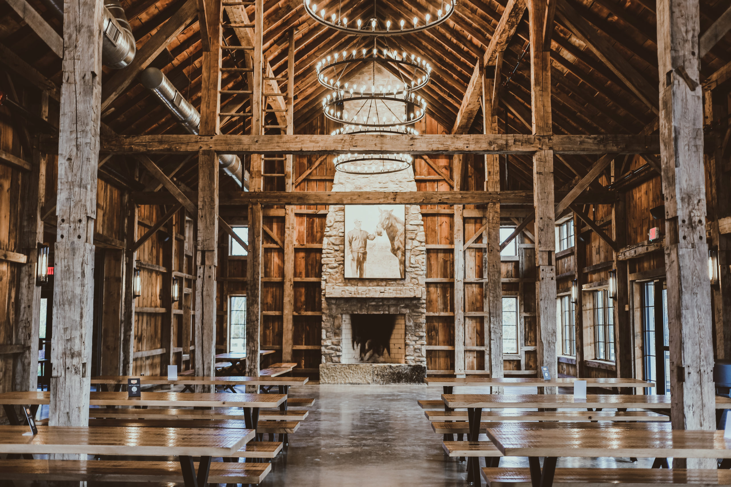 brewery with exposed beams, large chandeliers and stone fireplace