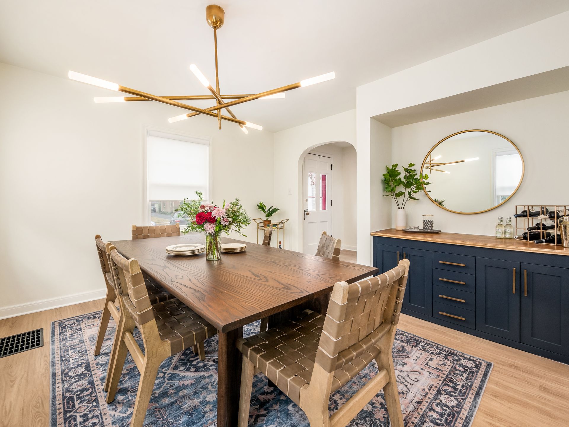 dining room with brass light fixture and blue bar