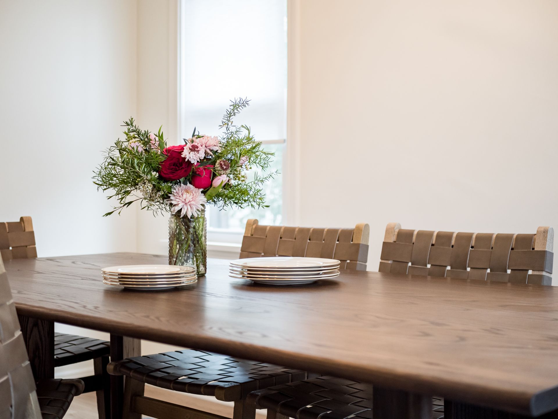 dining room with plates and flower centerpiece
