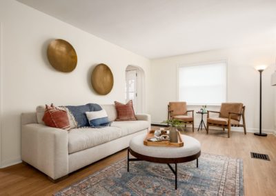 Living room with brass art, neutral, blush and blue tones