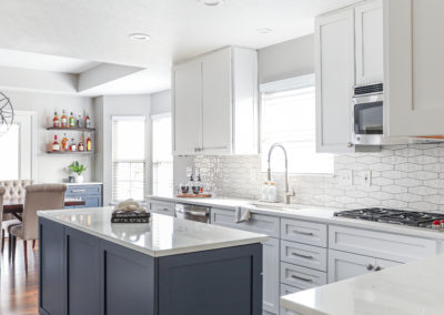 White Cabinetry Kitchen Remodel with Blue Island