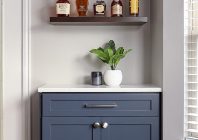 Whisky display with blue cabinetry