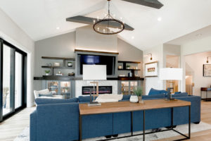 TV feature wall with cabinets, open shelving, chandelier and seating