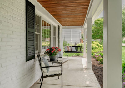 newly renovated front porch with newly designed seating areas and new garage door
